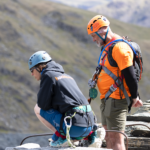 Climbers preparing to take on the Via Ferrata Extreme challenge at Honister Slate Mine in support of Always Another Way, with stunning Lake District mountain scenery in the background.